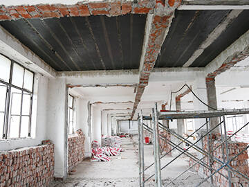 Retrofitting of administrative office building by anchoring adhesive